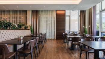 Modern Kommod restaurant with dark wooden interior and upholstered benches. Modern Kommod restaurant with dark wooden interior and upholstered benches.