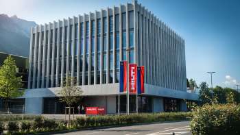 The architecturally impressive Hilti headquarters in Schaan - a modern industrial building with a view of the Alps.