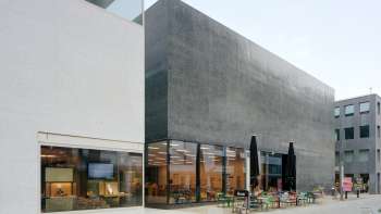 Exterior view of the Liechtenstein Art Museum with modern façade and café terrace in Vaduz.