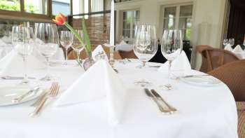 Stylishly laid table in the Vivid restaurant with elegant table decorations in a bright atmosphere