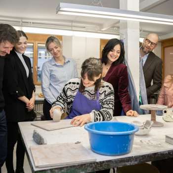 A group of interested visitors watch a potter modeling - a creative experience in a cozy atmosphere at the Schädler ceramics workshop in Nendeln.