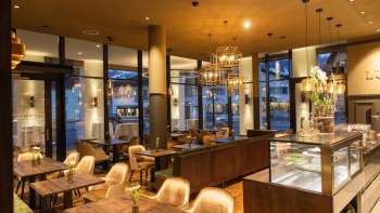 Elegant café with cozy seating areas, stylish furniture and a warm lighting ambience