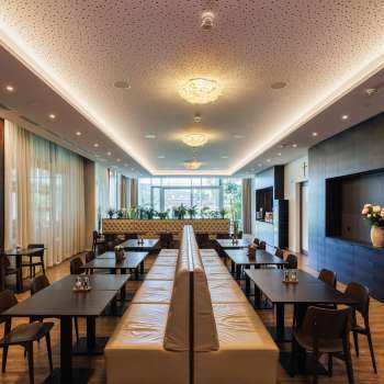 Bright dining room in the Kommod restaurant with stylish design and large windows.