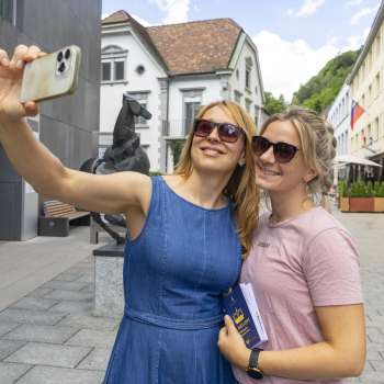 Two women are taking a selfie in Vaduz's old town