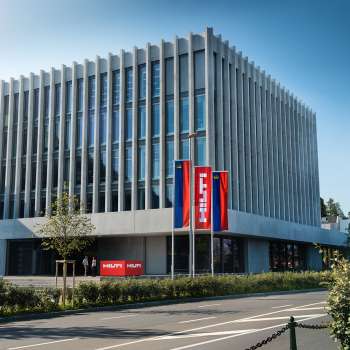 The architecturally impressive Hilti headquarters in Schaan - a modern industrial building with a view of the Alps.