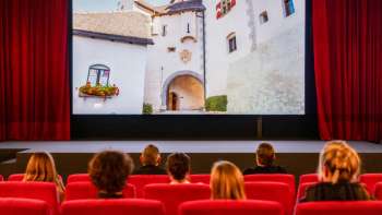 Guests sit in the old Vaduz cinema and watch the movie "Princely Moments"