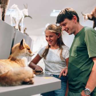 Father and daughter look at a stuffed animal in the Liechtenstein NationalMuseum