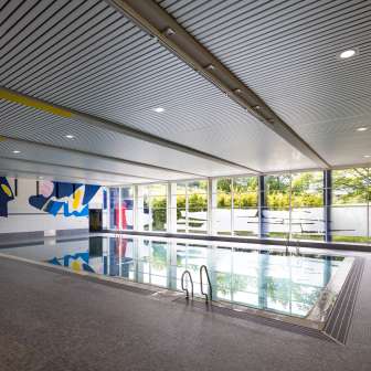 Modern Resch indoor pool in Schaan with wall art, large windows and swimming pool in Liechtenstein