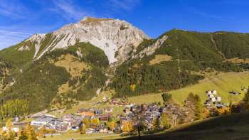 View of the mountain village of Malbun in Liechtenstein with the surrounding mountain landscape under a clear sky.