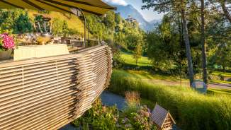 Evening sun on the terrace of the Park Hotel Sonnenhof in Liechtenstein, with a view of Vaduz Castle and the picturesque Alpine landscape