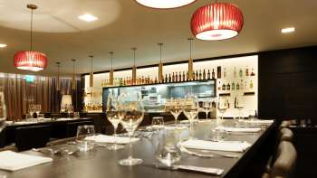 Modern bar in the Kokon restaurant with stylish wine glasses and atmospheric lighting design