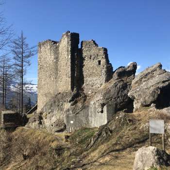 The ruins of Schalun Castle nestled in a glowing autumnal forest - a romantic excursion destination above Vaduz.
