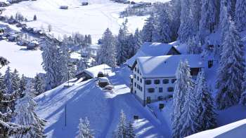 Traditional mountain inn Sücka in the middle of a green landscape and surrounded by forests