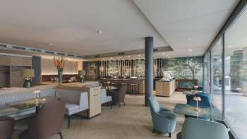Modern restaurant with stylish interior design, comfortable armchairs and large windows