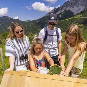 Family at one of the ten stations of the Alpine Heart Trail
