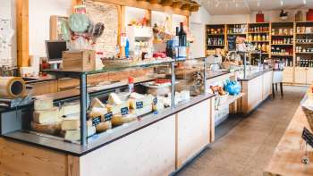 Modern sales room of the Bangshof farm store in Liechtenstein with regional products such as cheese, yogurt and fruit.
